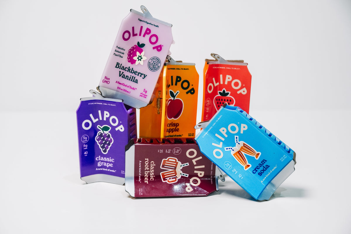 Six hair claws that look like OLIPOP Cans. The flavors featured are Blackberry Vanilla, Classic Grape, Classic Root Beer, Cream Soda, Crisp Apple, and Strawberry Vanilla