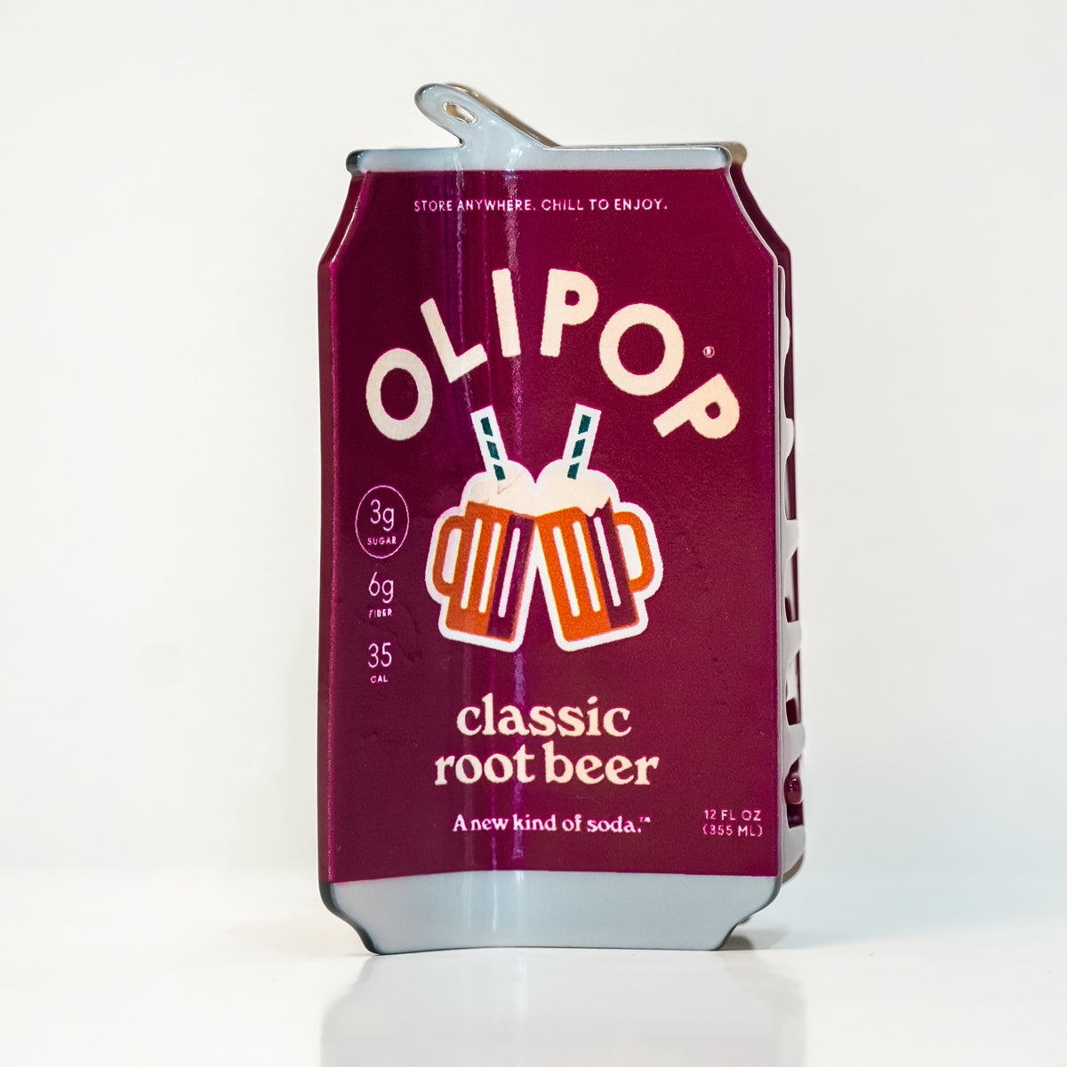 a hair claw designed to look like an OLIPOP classic root beer can with a metallic burgundy label and silver top/bottom. the design features the OLIPOP branding and drink information, as well as an illustration of two root beer glasses