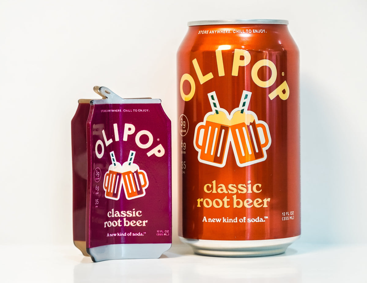 An OLIPOP Classic Root Beer hair claw next to a real can of Classic Root Beer olipop