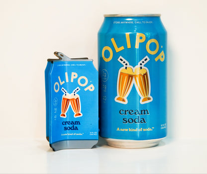 An Olipop Cream Soda hair claw next to a can of Olipop Cream soda